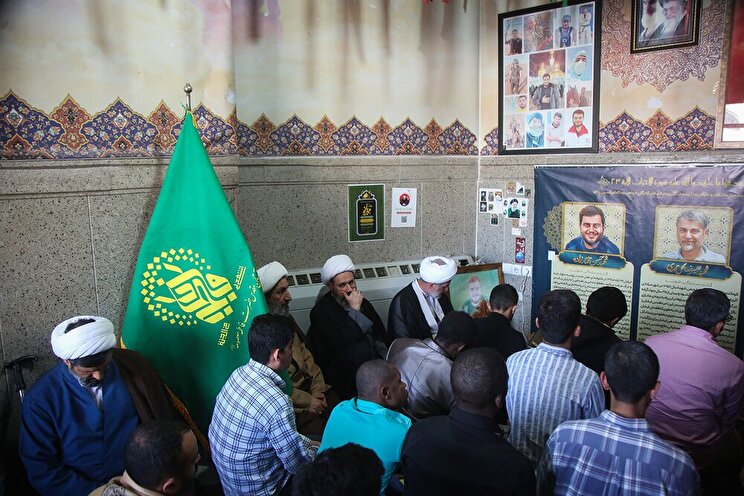 طلاب غیر إیرانیون یُکرّمون شهداء قم عند مرقد المعصومة (ع)